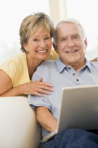 An older couple using a laptop.